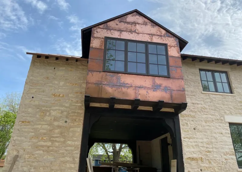 Copper metal panel facade on a stone building for Roof Repair in Clearlake