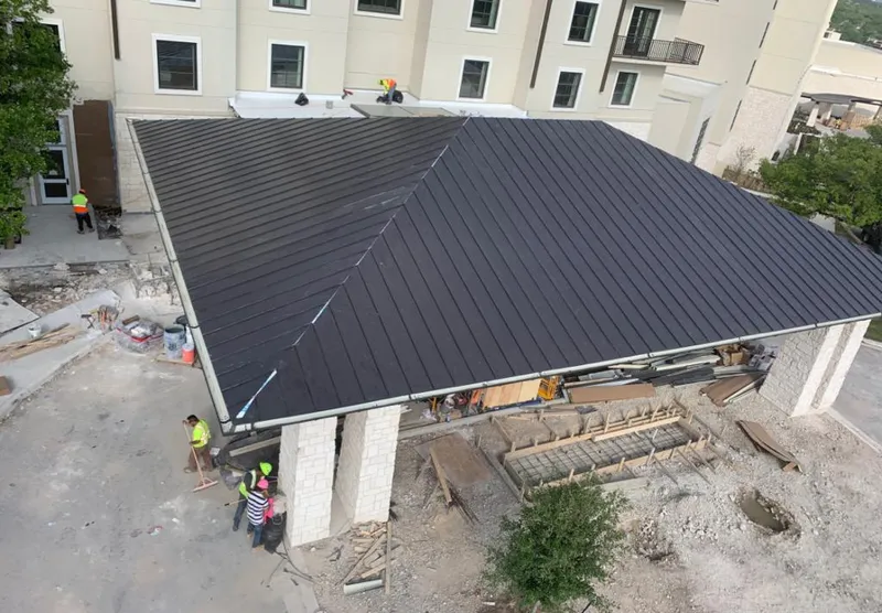 Metal roofing installation team working on a commercial building in Clearlake